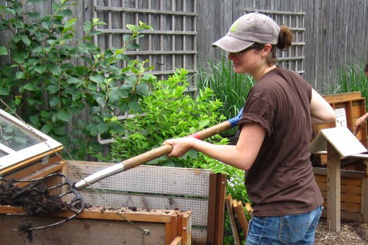 woman shoveling compost