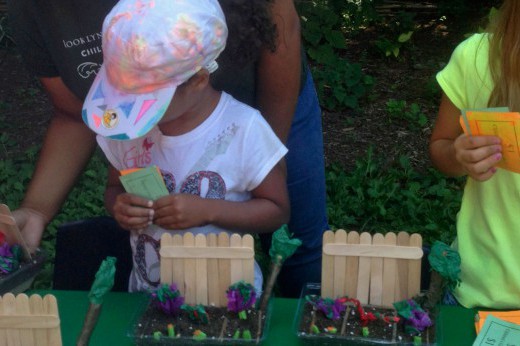 two children shop for crafts using play money